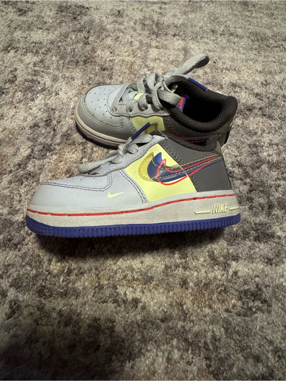 Nike Kids Light Gray Sneakers with Yellow and Purple Accents